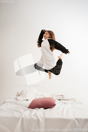 Image of Little girl in soft warm pajama having party colored bright playing at home