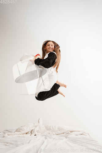 Image of Little girl in soft warm pajama having party colored bright playing at home