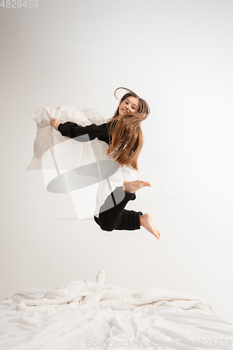 Image of Little girl in soft warm pajama having party colored bright playing at home