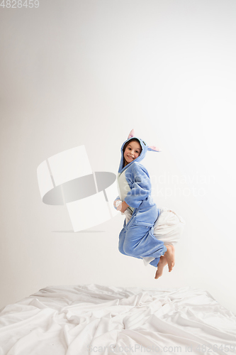 Image of Little girl in soft warm pajama having party colored bright playing at home