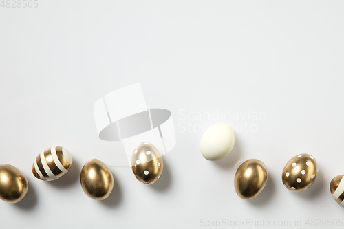 Image of Egg hunt is coming. Easter traditions, golden colored eggs, top view