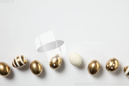 Image of Egg hunt is coming. Easter traditions, golden colored eggs, top view