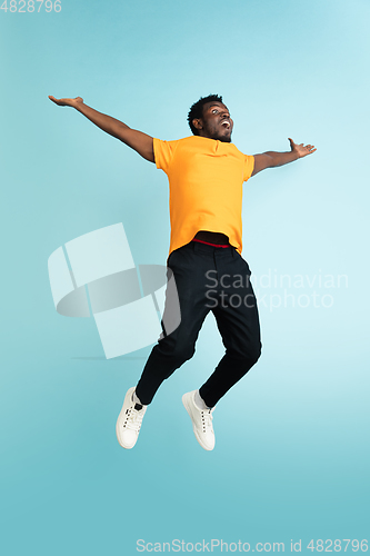 Image of Full length portrait of African young man isolated over blue studio background with copyspace