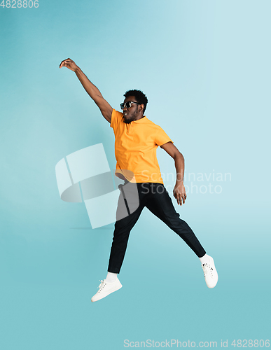 Image of Full length portrait of African young man isolated over blue studio background with copyspace