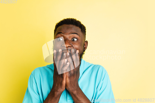 Image of Portrait of young African man isolated over yellow studio background with copyspace.