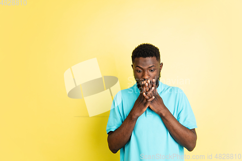 Image of Portrait of young African man isolated over yellow studio background with copyspace.