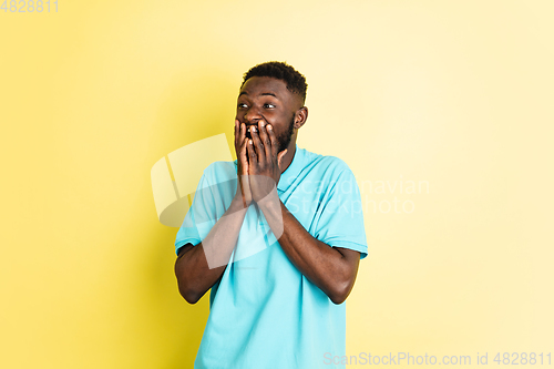 Image of Portrait of young African man isolated over yellow studio background with copyspace.