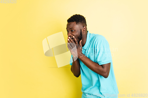 Image of Portrait of young African man isolated over yellow studio background with copyspace.