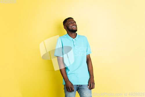 Image of Portrait of young African man isolated over yellow studio background with copyspace.