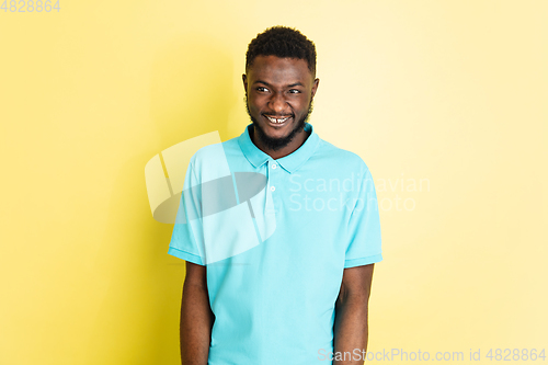 Image of Portrait of young African man isolated over yellow studio background with copyspace.