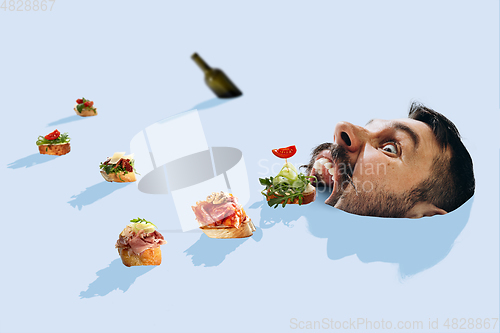 Image of Tapas and wine bottle are descending with the river like ships straight to big male mouth just like to the cave