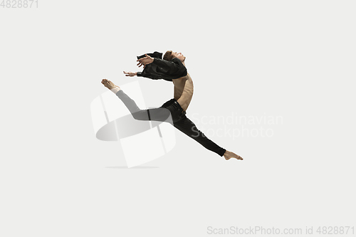 Image of Man in casual style clothes jumping and dancing isolated on white background. Art, motion, action, flexibility, inspiration concept. Flexible caucasian ballet dancer.