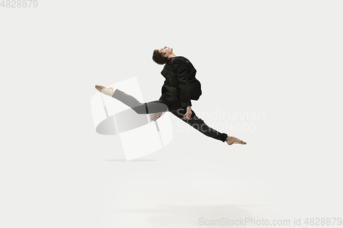 Image of Man in casual style clothes jumping and dancing isolated on white background. Art, motion, action, flexibility, inspiration concept. Flexible caucasian ballet dancer.