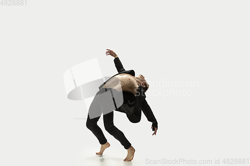 Image of Man in casual style clothes jumping and dancing isolated on white background. Art, motion, action, flexibility, inspiration concept. Flexible caucasian ballet dancer.