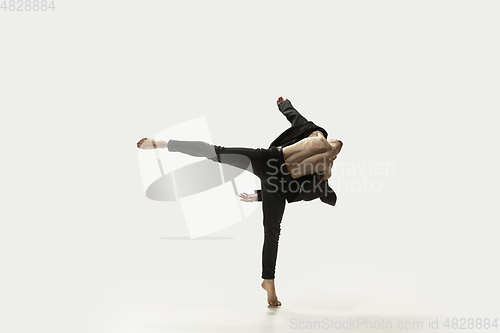 Image of Man in casual style clothes jumping and dancing isolated on white background. Art, motion, action, flexibility, inspiration concept. Flexible caucasian ballet dancer.