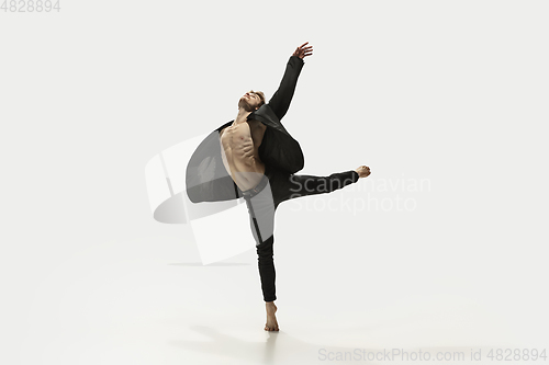 Image of Man in casual style clothes jumping and dancing isolated on white background. Art, motion, action, flexibility, inspiration concept. Flexible caucasian ballet dancer.