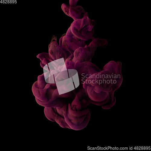 Image of Explosion of colored, fluid and neoned liquids on black studio background with copyspace