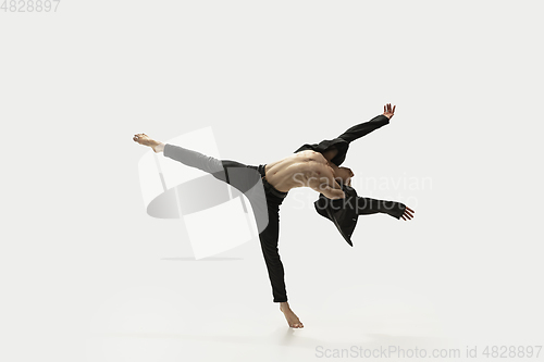 Image of Man in casual style clothes jumping and dancing isolated on white background. Art, motion, action, flexibility, inspiration concept. Flexible caucasian ballet dancer.