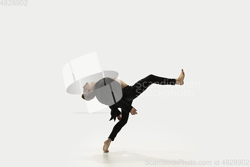 Image of Man in casual style clothes jumping and dancing isolated on white background. Art, motion, action, flexibility, inspiration concept. Flexible caucasian ballet dancer.