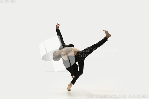 Image of Man in casual style clothes jumping and dancing isolated on white background. Art, motion, action, flexibility, inspiration concept. Flexible caucasian ballet dancer.