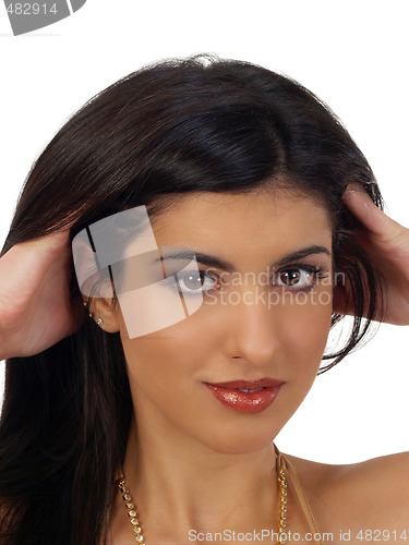 Image of Young middle eastern woman portrait with hands in hair