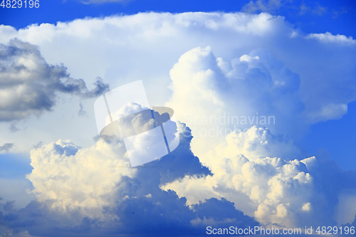 Image of Big white clouds on blue sky. Heaven view