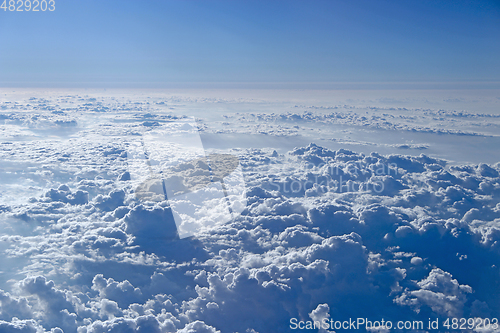 Image of Flight over clouds. Wonderful panorama from window of plane with white clouds