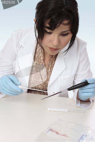 Image of Forensic scientist obtaining sample 