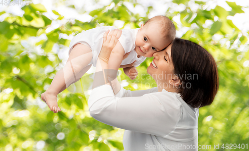 Image of happy middle-aged mother with little baby daughter