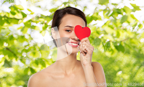 Image of beautiful woman closing one eye with pink heart