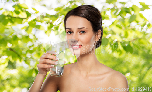 Image of woman drinking water with cucumber and ice