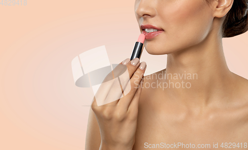 Image of beautiful smiling young woman with pink lipstick