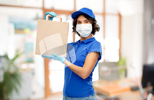 Image of delivery woman in mask with food in bag at office