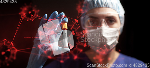 Image of doctor holding beaker with coronavirus blood test