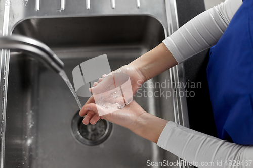 Image of doctor or nurse washing hands with liquid soap