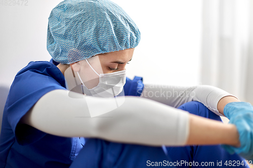 Image of sad doctor or nurse in protective face mask