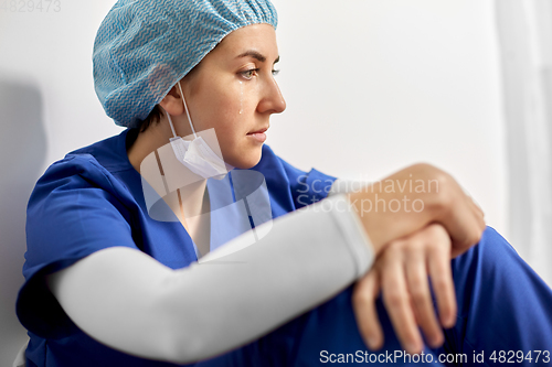 Image of crying female doctor or nurse at hospital