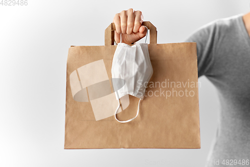 Image of woman with shopping bag and face protective mask