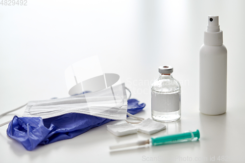 Image of syringe, medicine, wound wipes, gloves and mask