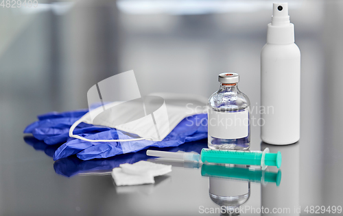 Image of syringe, medicine, wound wipes, gloves and mask