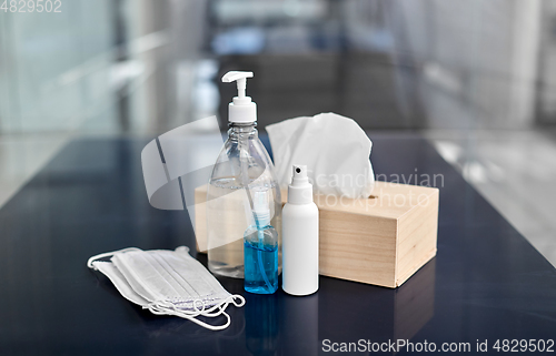 Image of hand sanitizers, masks, liquid soap and tissues