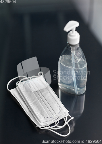 Image of hand sanitizer or liquid soap and medical masks