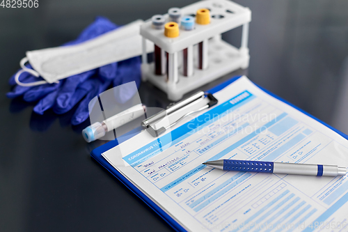 Image of medical report, blood tests, gloves and mask