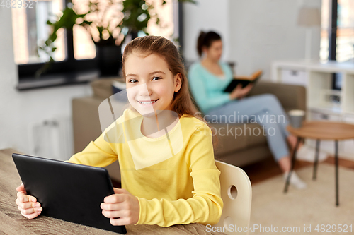 Image of student girl with tablet pc and mother at home