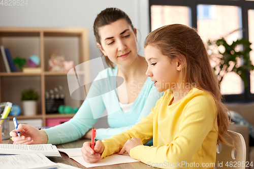 Image of mother and daughter doing homework together