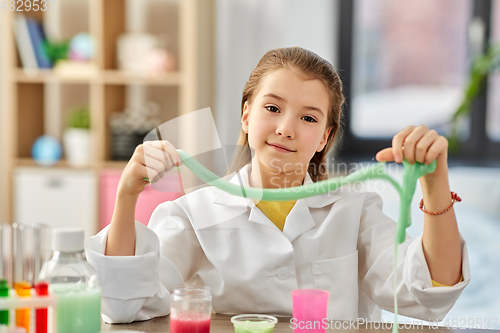 Image of girl playing with slime at home laboratory