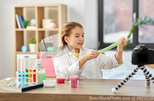 Image of girl with slime and camera video blogging at home