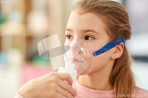 Image of sick little girl wearing oxygen mask