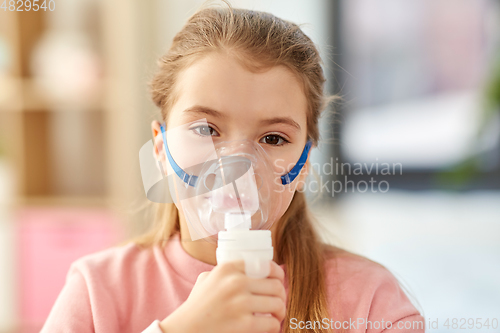 Image of sick little girl wearing oxygen mask