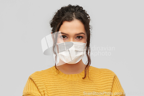 Image of young woman in protective medical mask